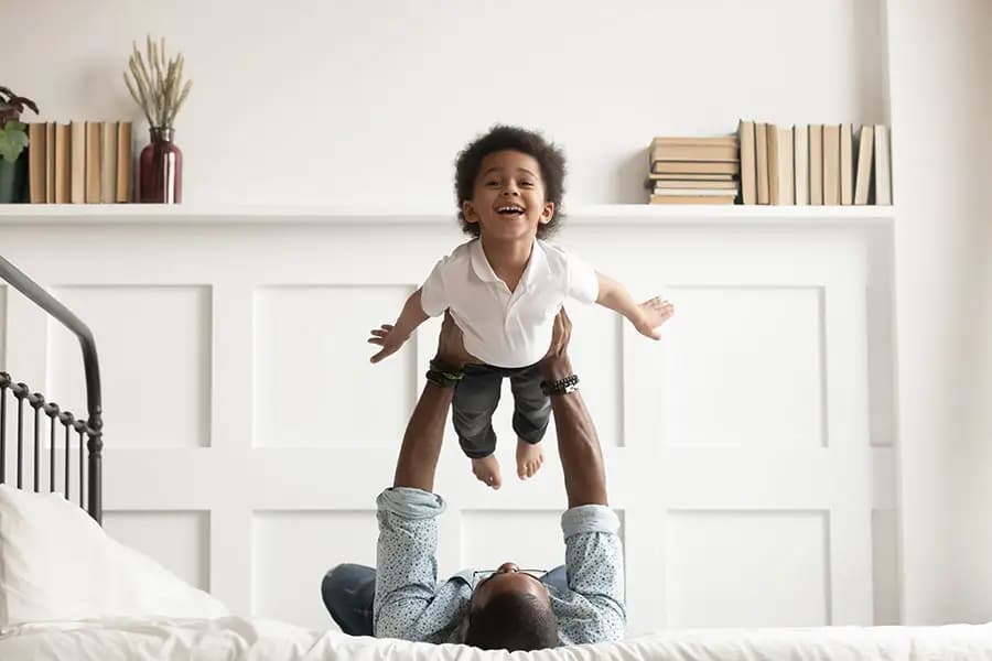 toddler-playing-airplane-with-dad