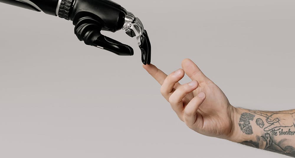 Human hand and robot hand touch fingertip to fingertip