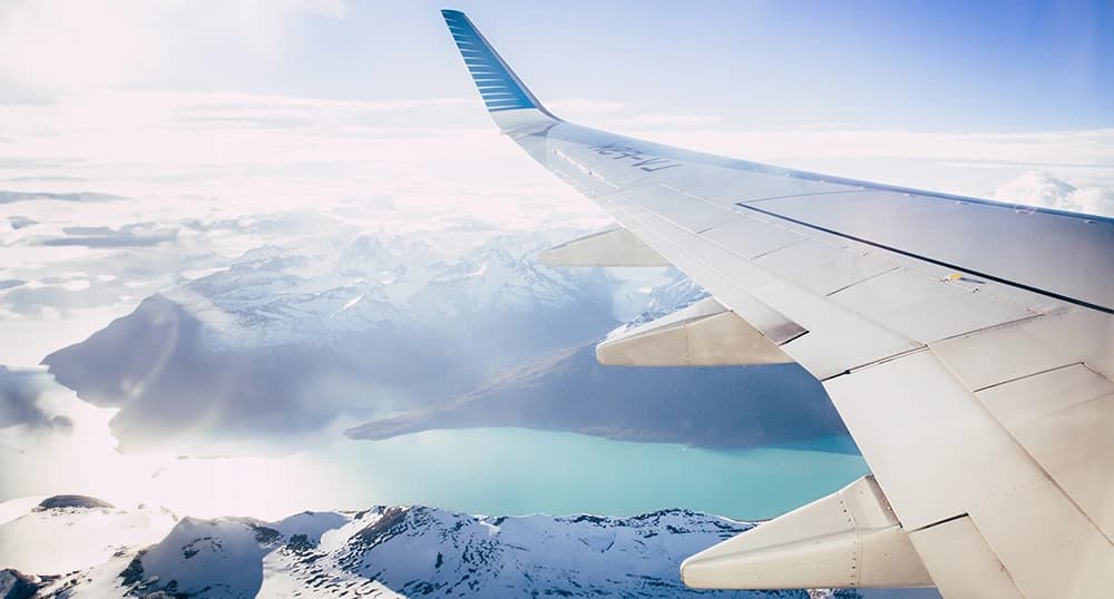 Airplane over snowy mountains