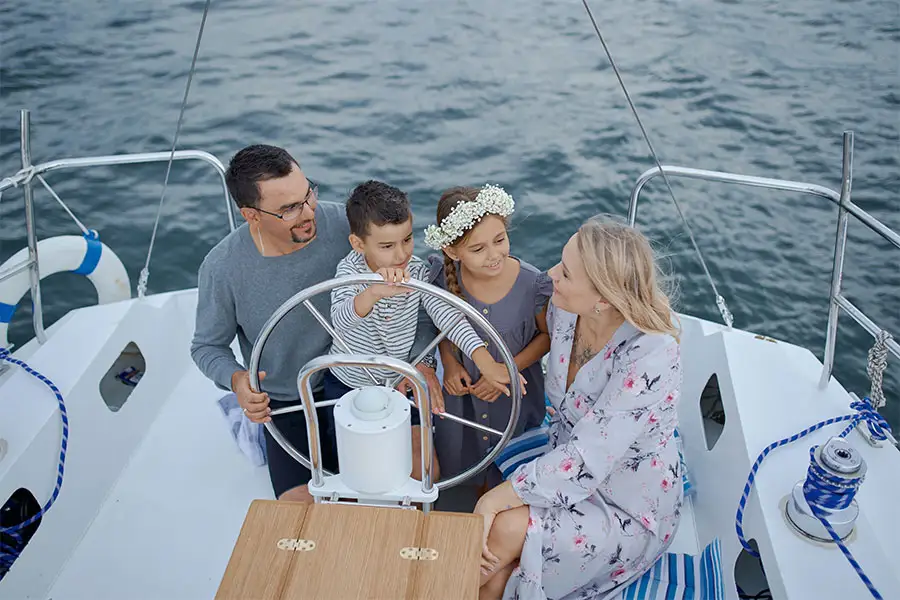 Family of 4 riding on a yacht-like boat