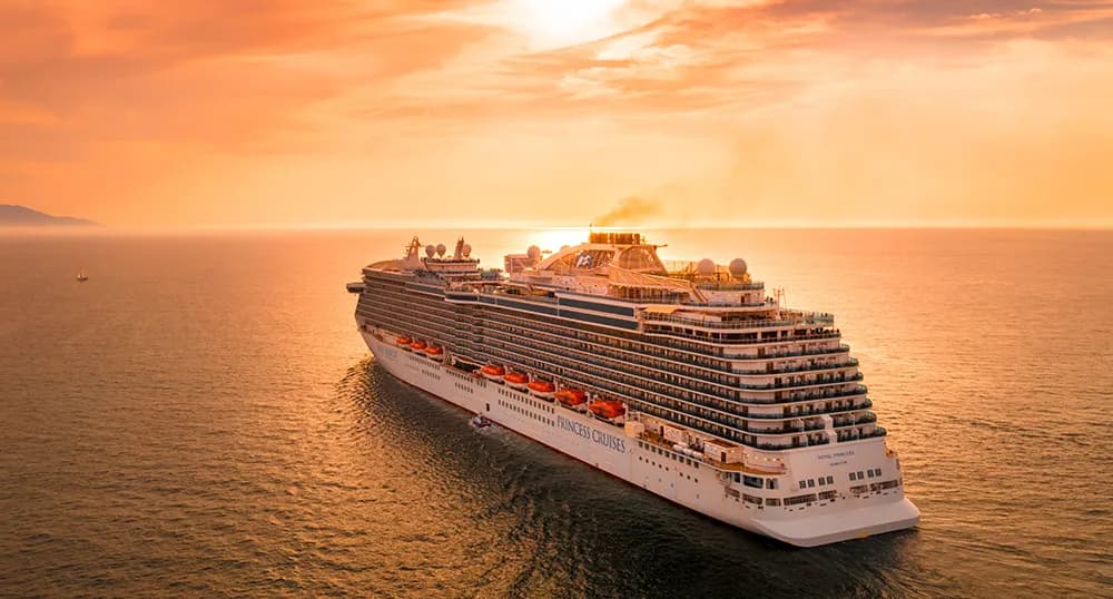 Cruise ship sails at sunset