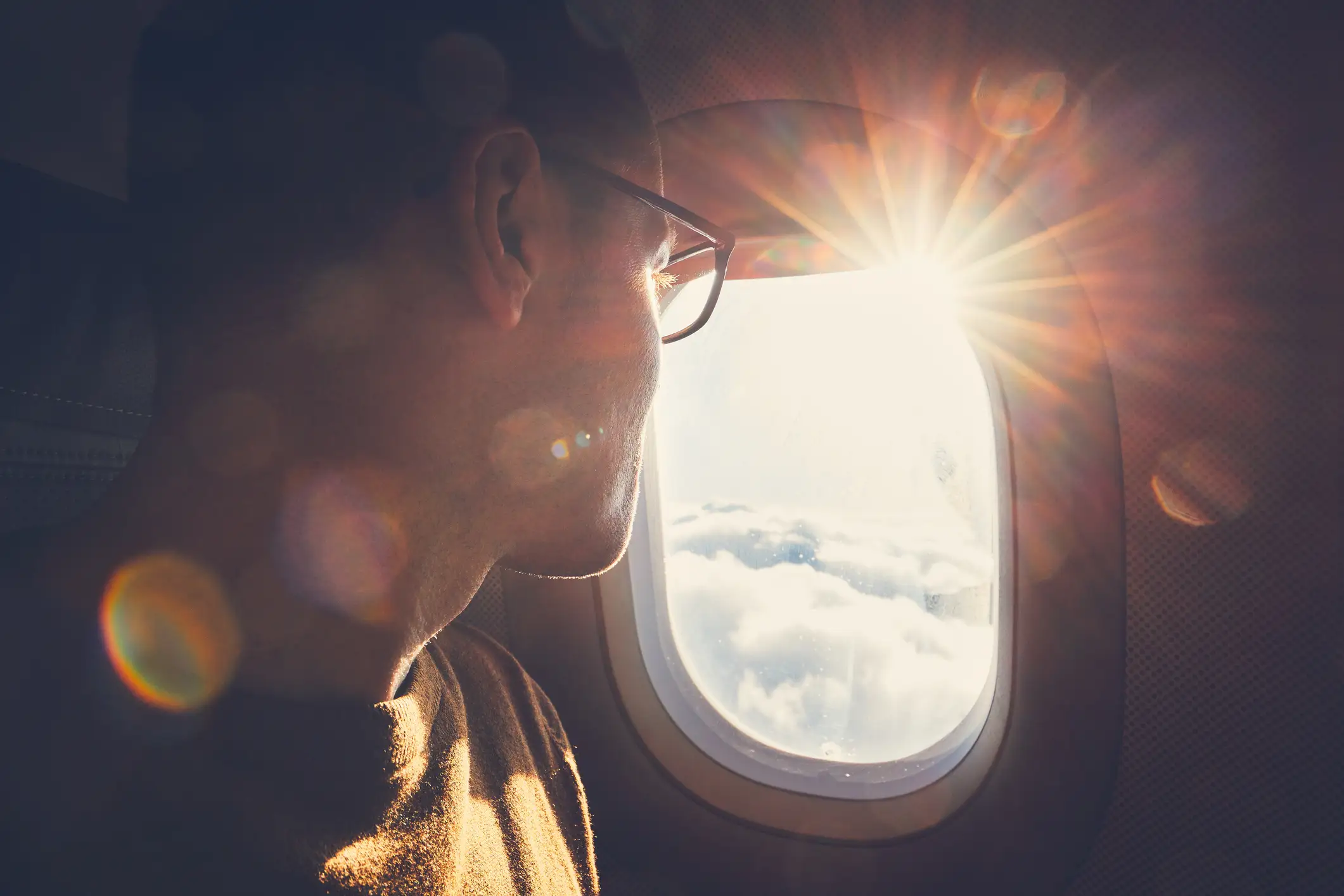 Man looks out an airplane window