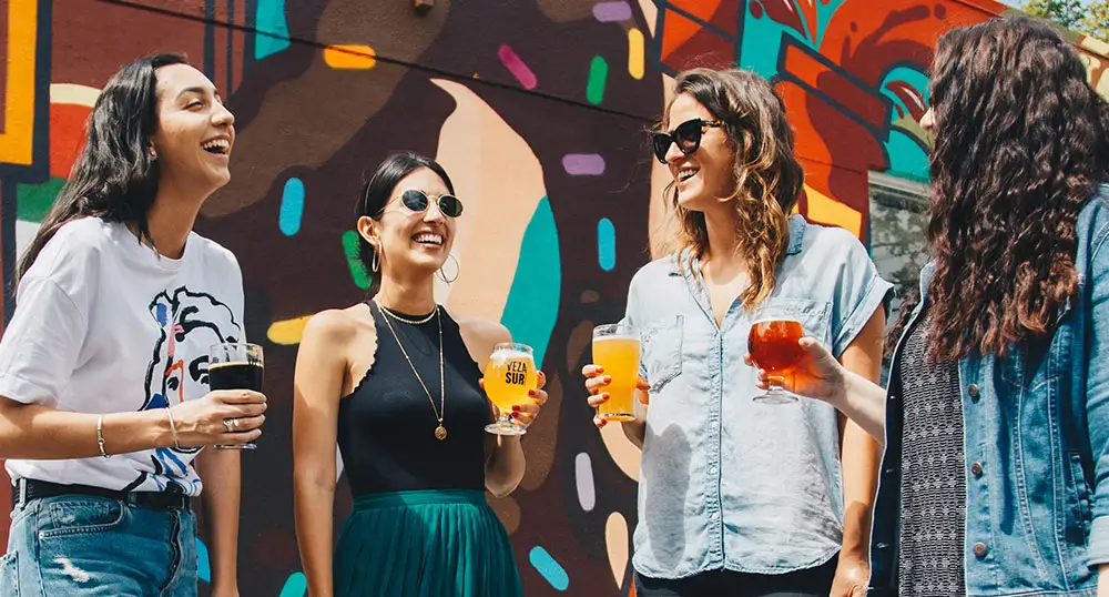 Group of female friends share drinks